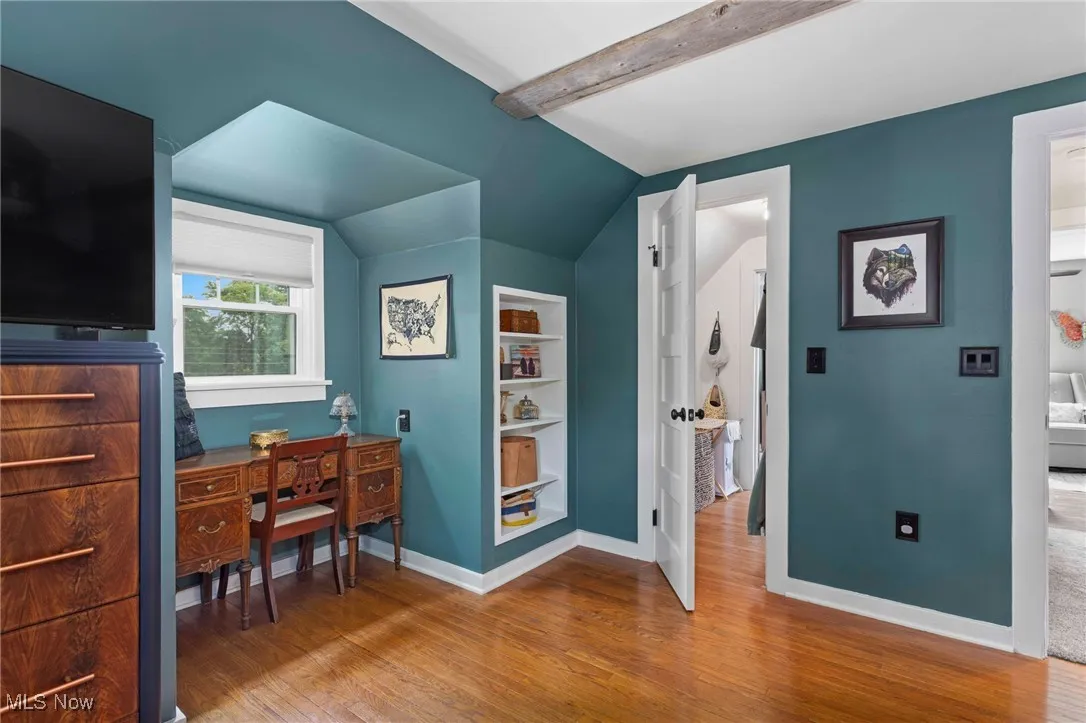 Office space with wood finished floors and built in features