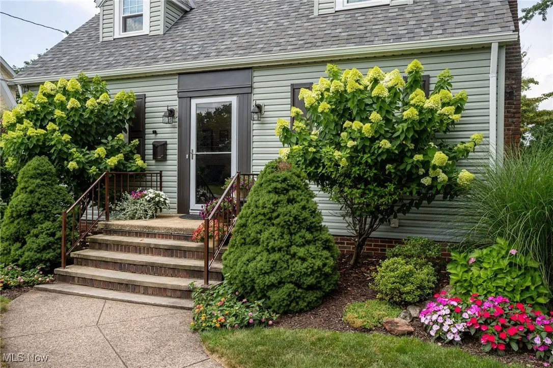 Entrance to property with a shingled roof
