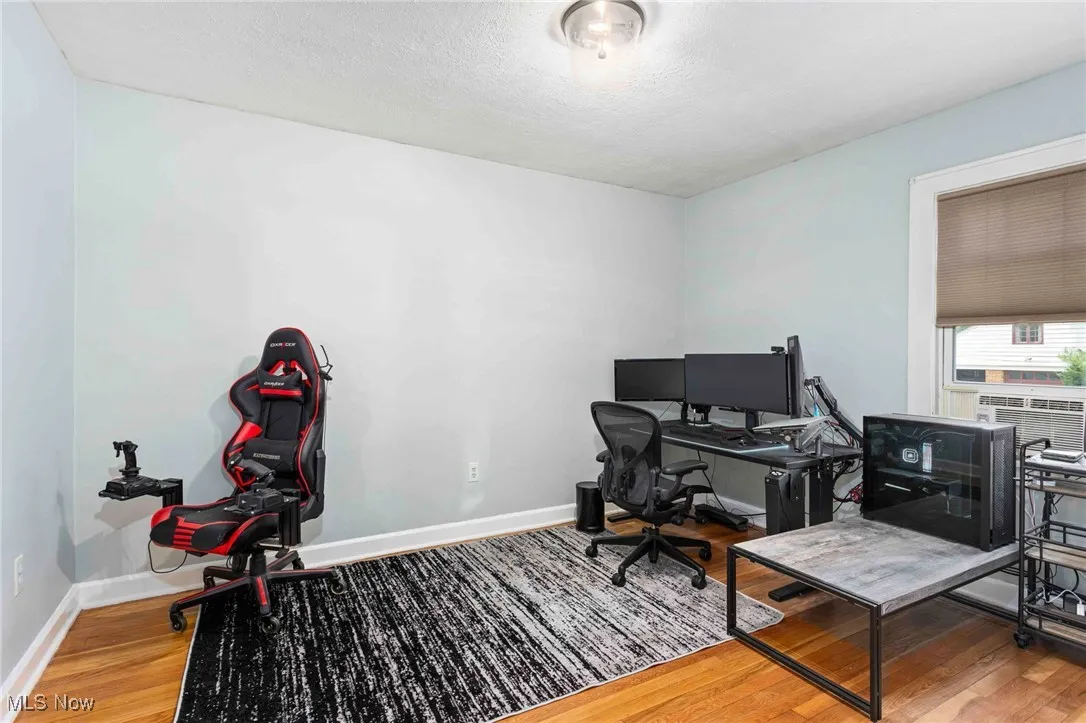 Office space featuring wood finished floors and a textured ceiling
