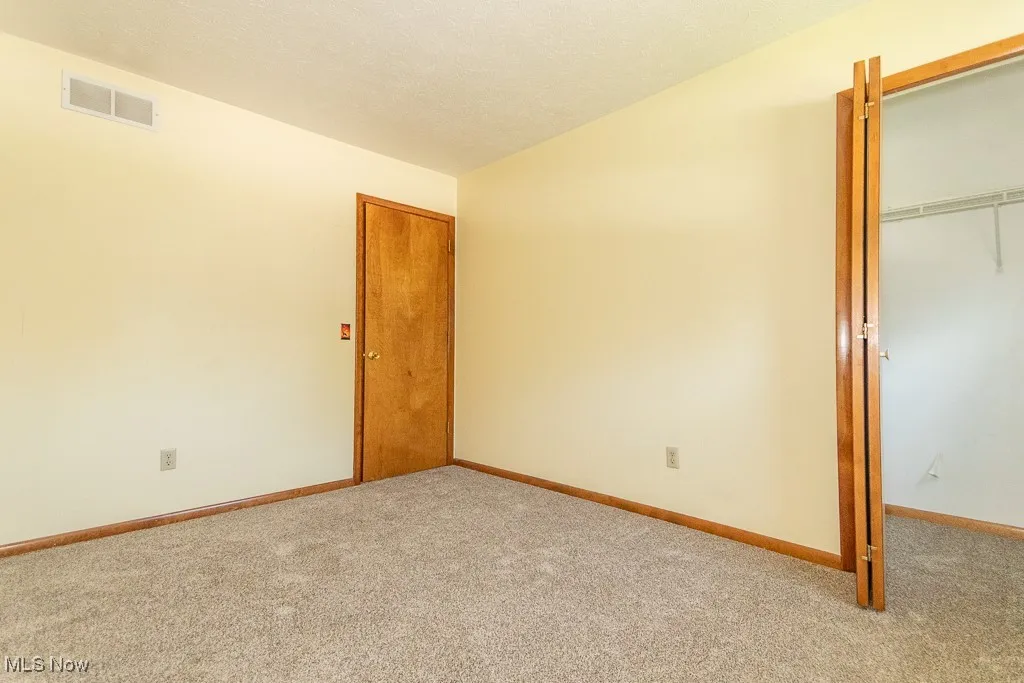 Unfurnished bedroom featuring carpet floors and a closet