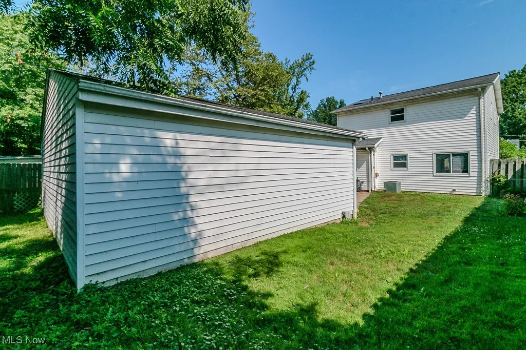 Rear view of property with an outbuilding