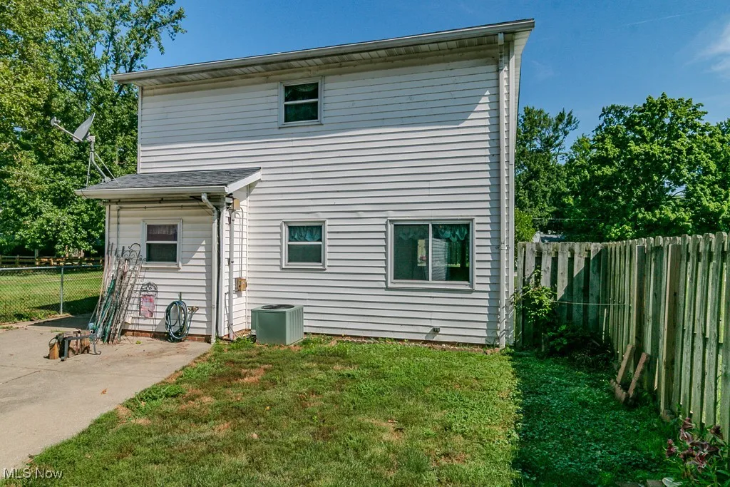 Back of property with a fenced backyard and a patio