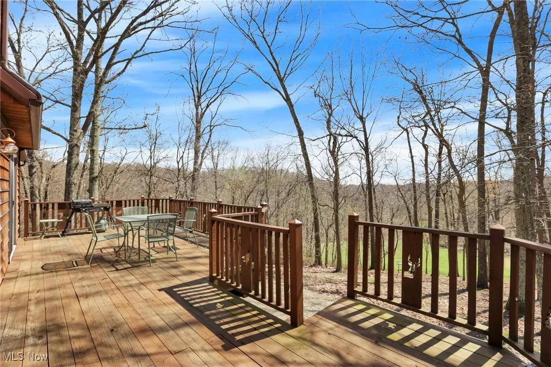 Wooden deck featuring outdoor dining area