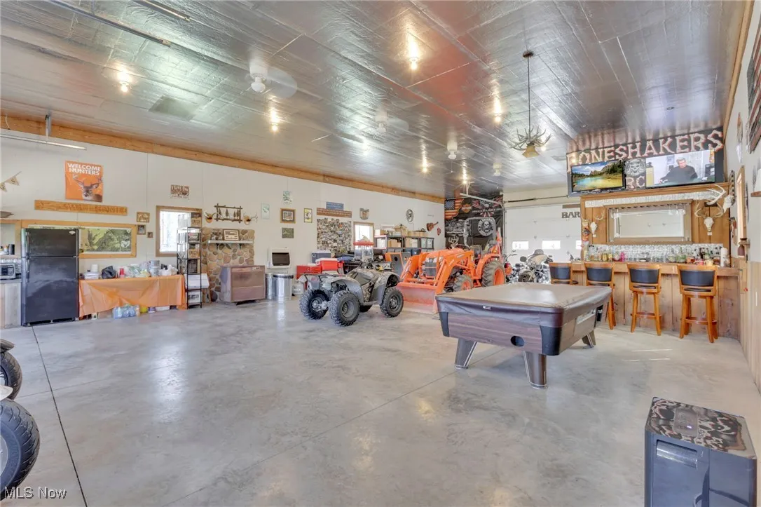 Garage featuring freestanding refrigerator