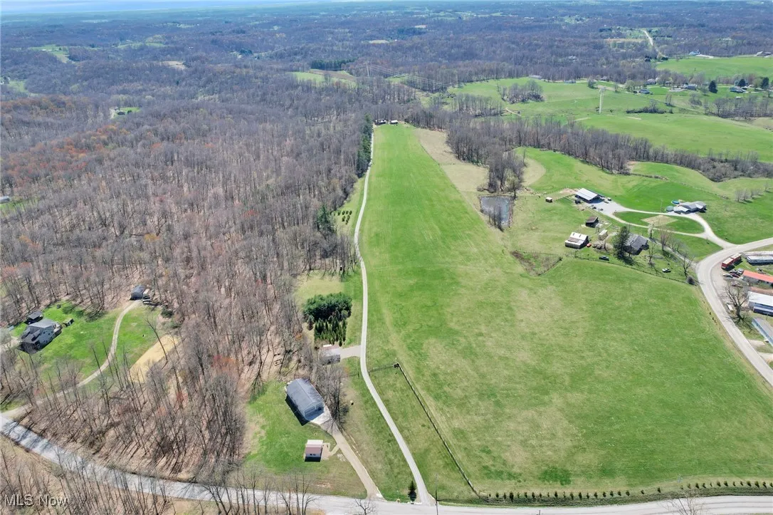 Aerial view of property's location with a heavily wooded area