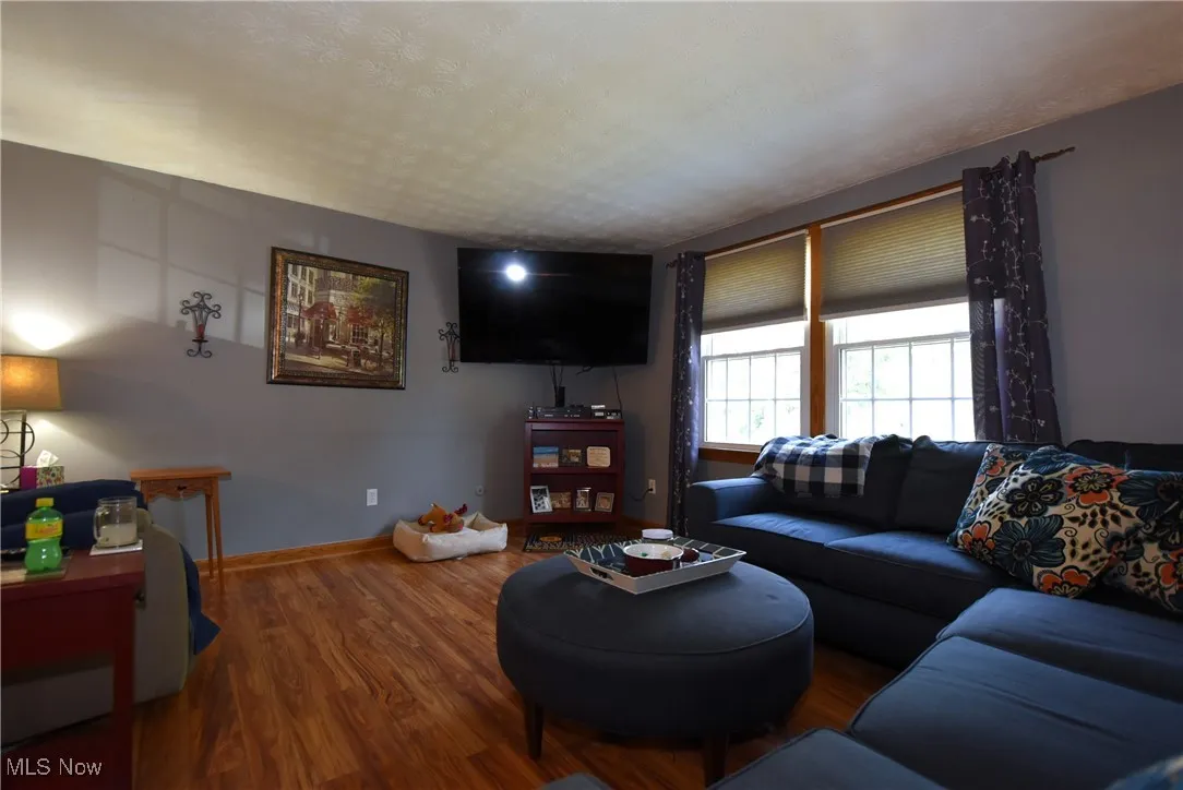 Living room with wood finished floors and baseboards