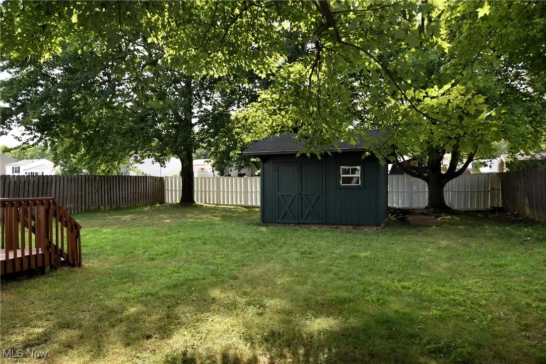 Fenced backyard with a shed