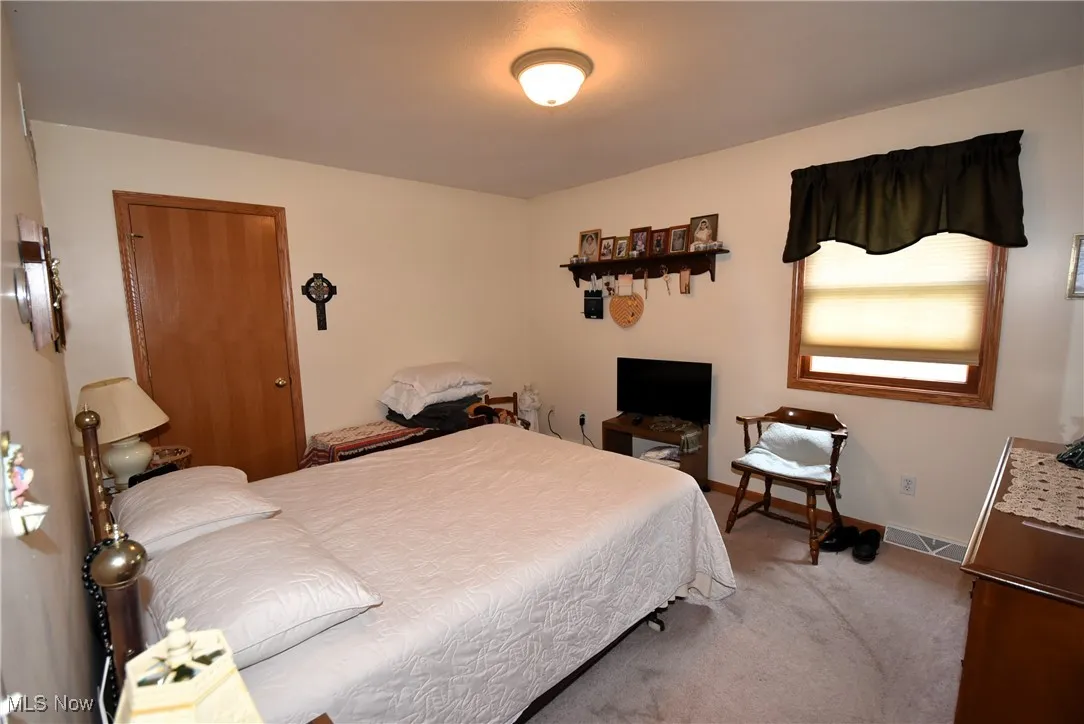 Bedroom featuring carpet floors and baseboards