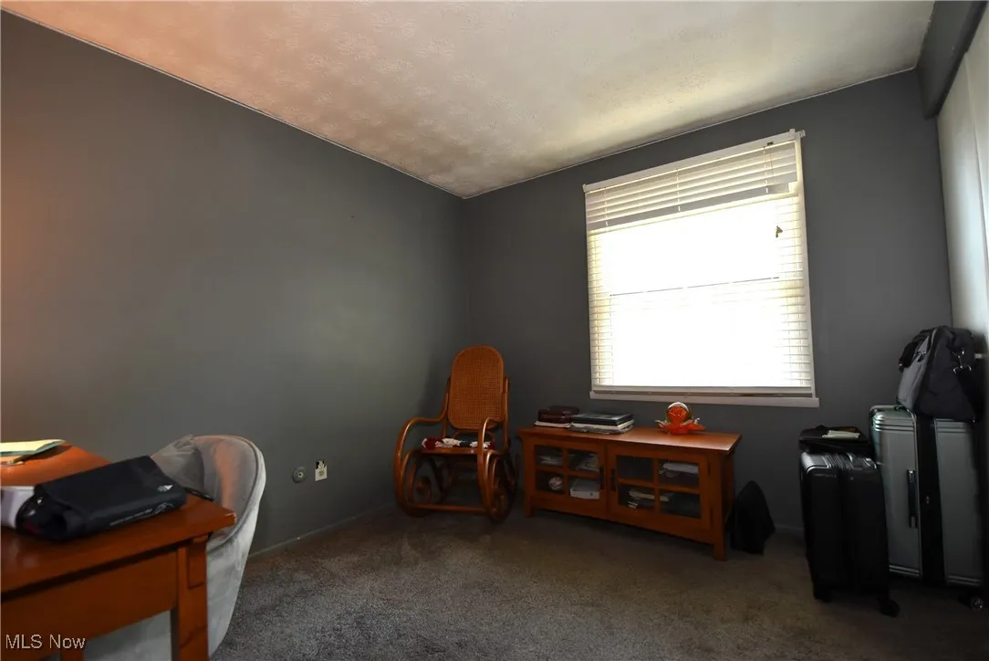 Carpeted office space featuring baseboards