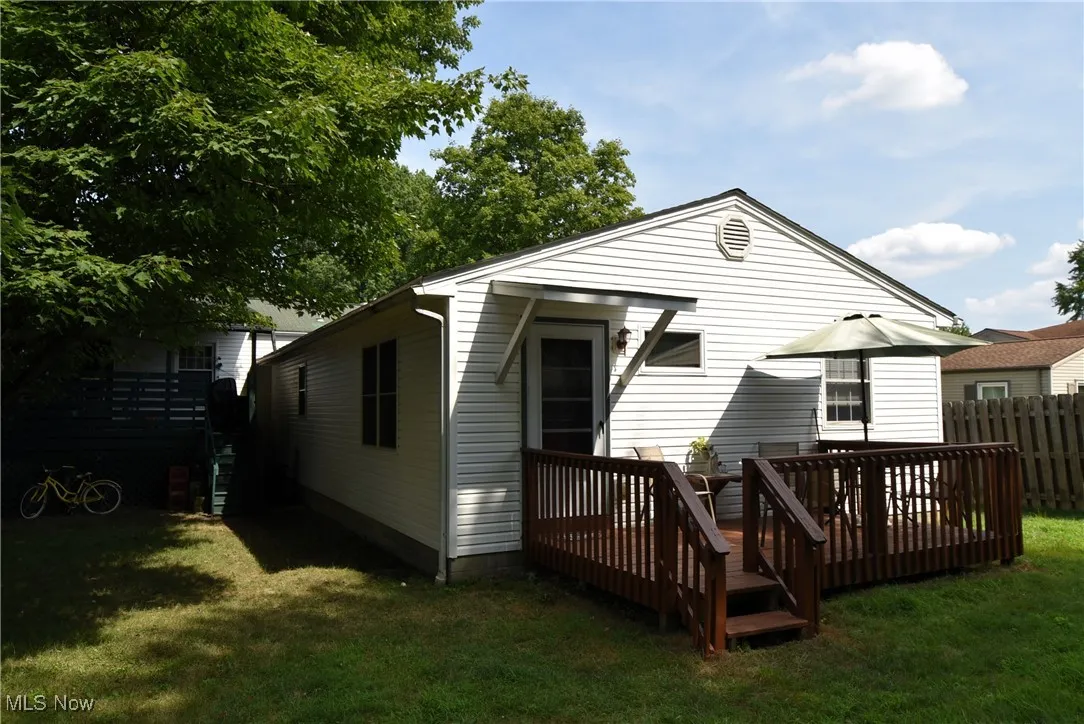 Back of house with a deck