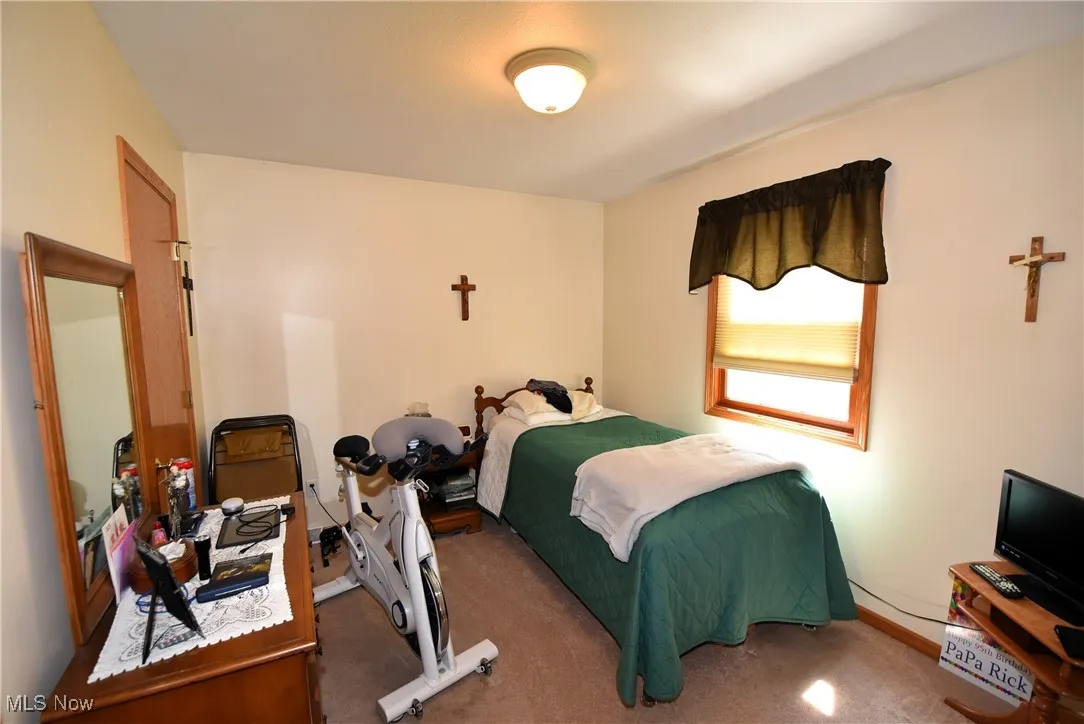 Carpeted bedroom with baseboards