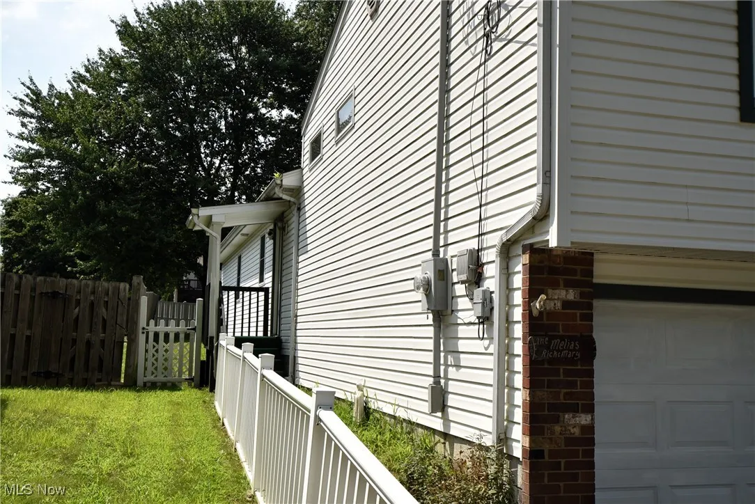 View of property exterior with a garage and brick siding