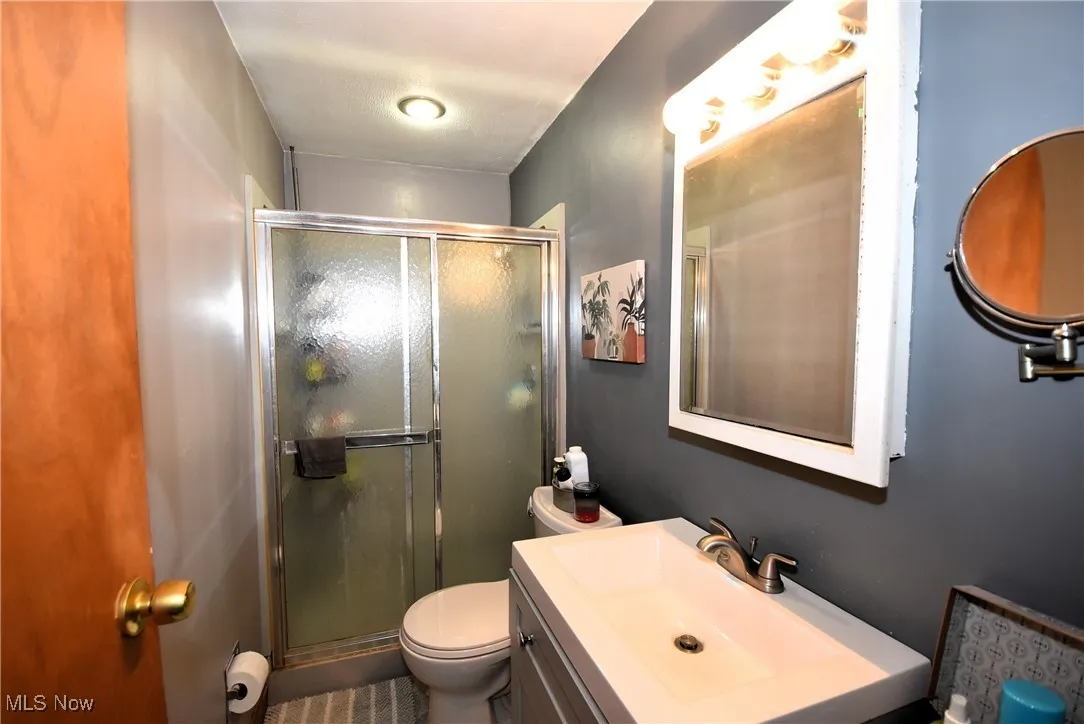 Bathroom featuring a shower stall and vanity