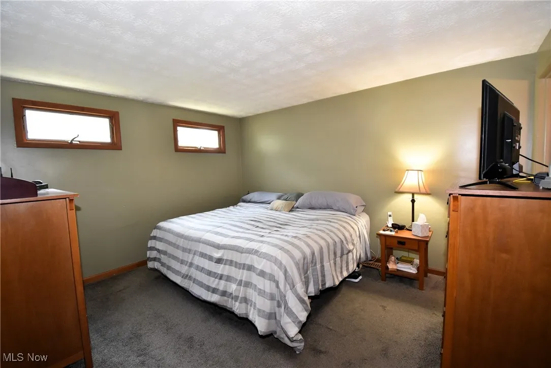 Bedroom featuring carpet flooring and a textured ceiling