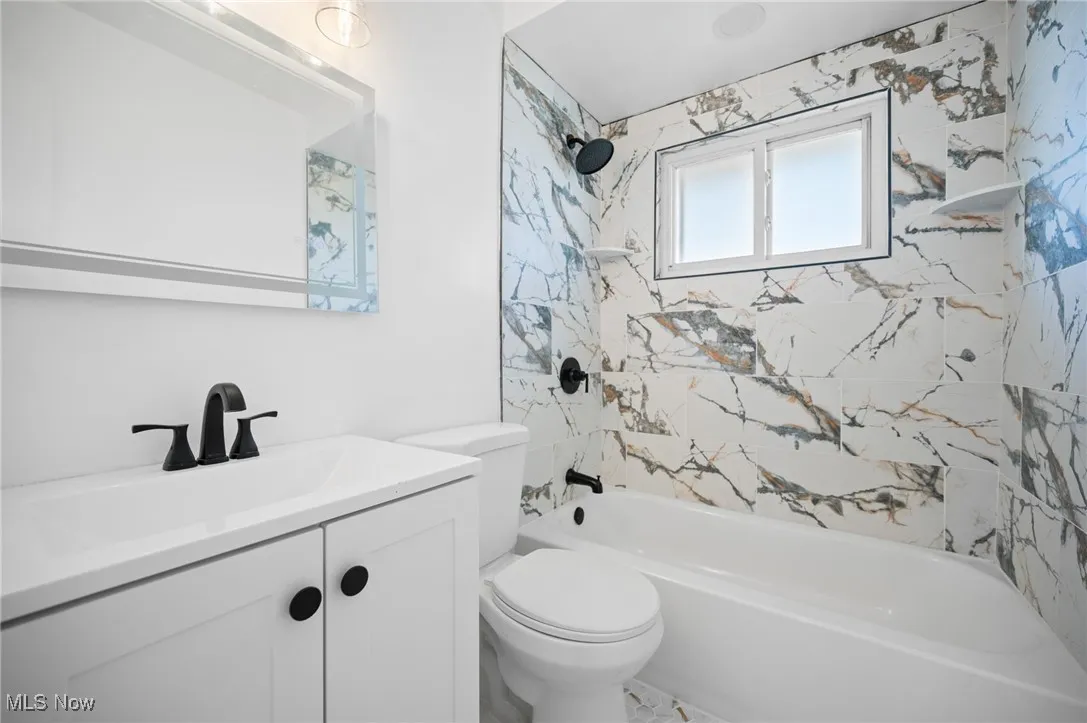 Full bath with vanity and tub / shower combination