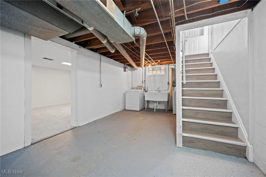 Unfinished basement with washer / dryer and stairs