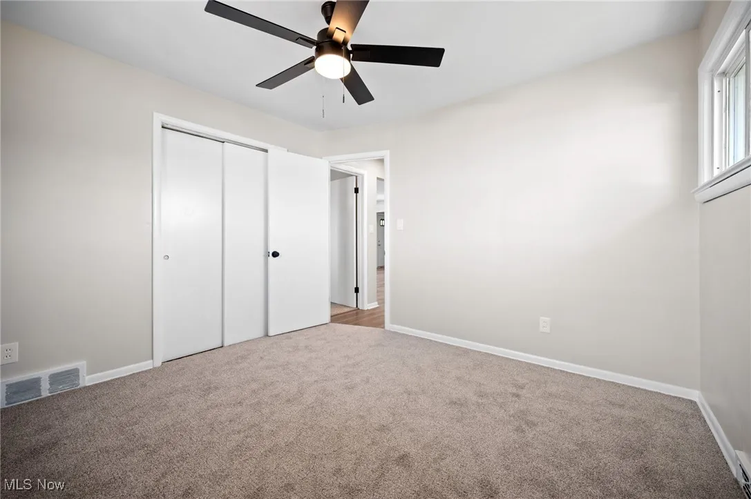 bedroom featuring carpet flooring, a closet, and a ceiling fan