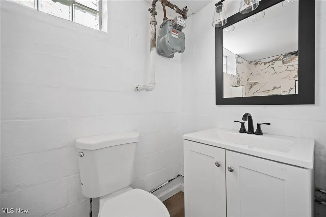 Bathroom featuring vanity and wood finished floors