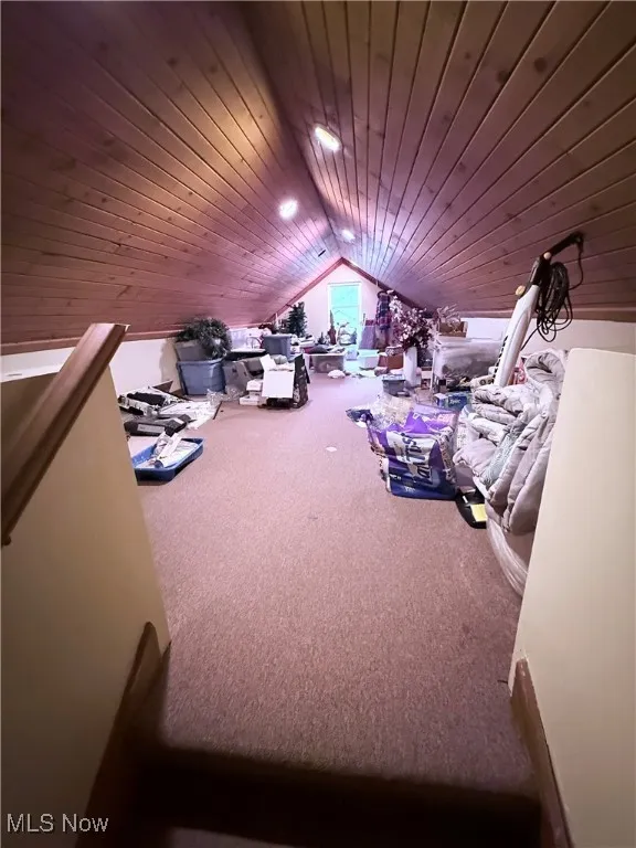 Additional living space featuring wooden ceiling, carpet, and vaulted ceiling