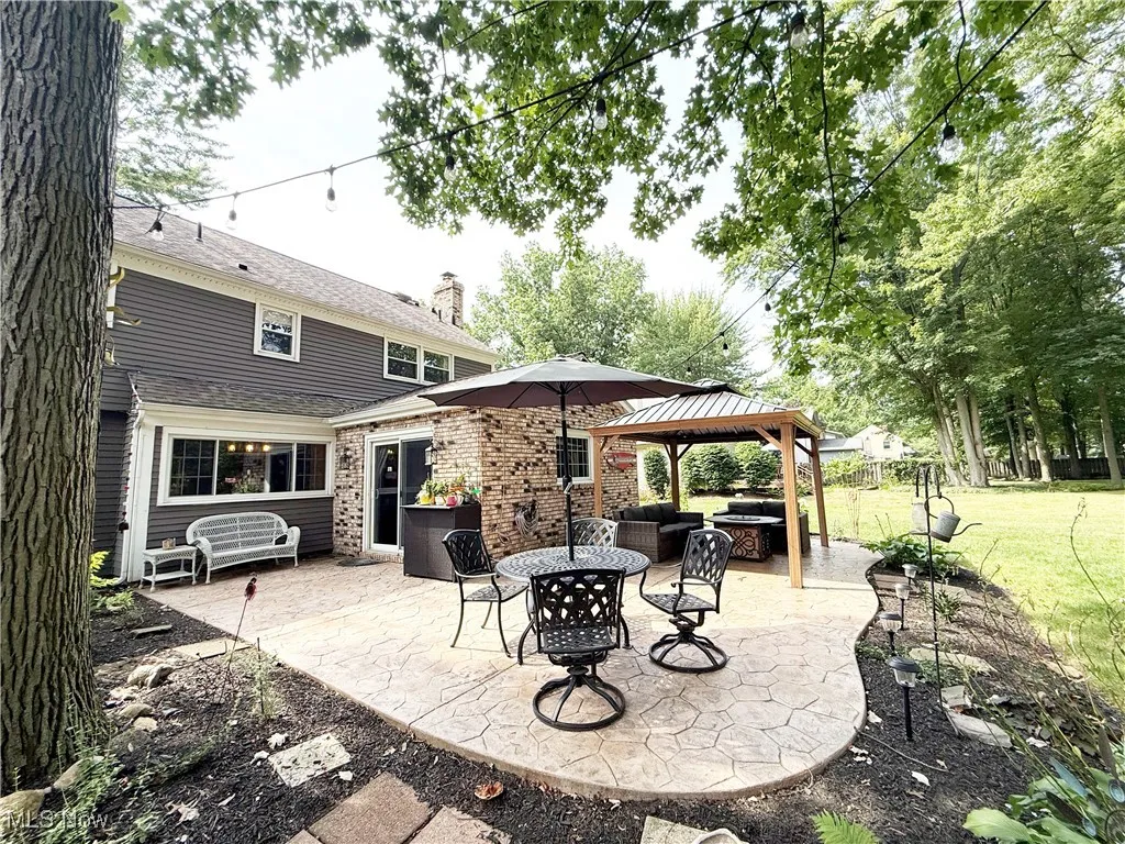View of patio with a gazebo and an outdoor hangout area