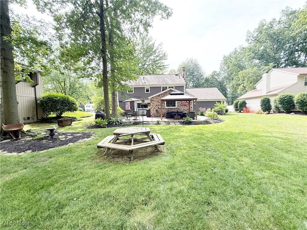 View of green lawn with a patio