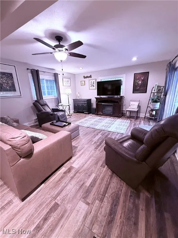Living room featuring wood finished floors, a ceiling fan, and recessed lighting