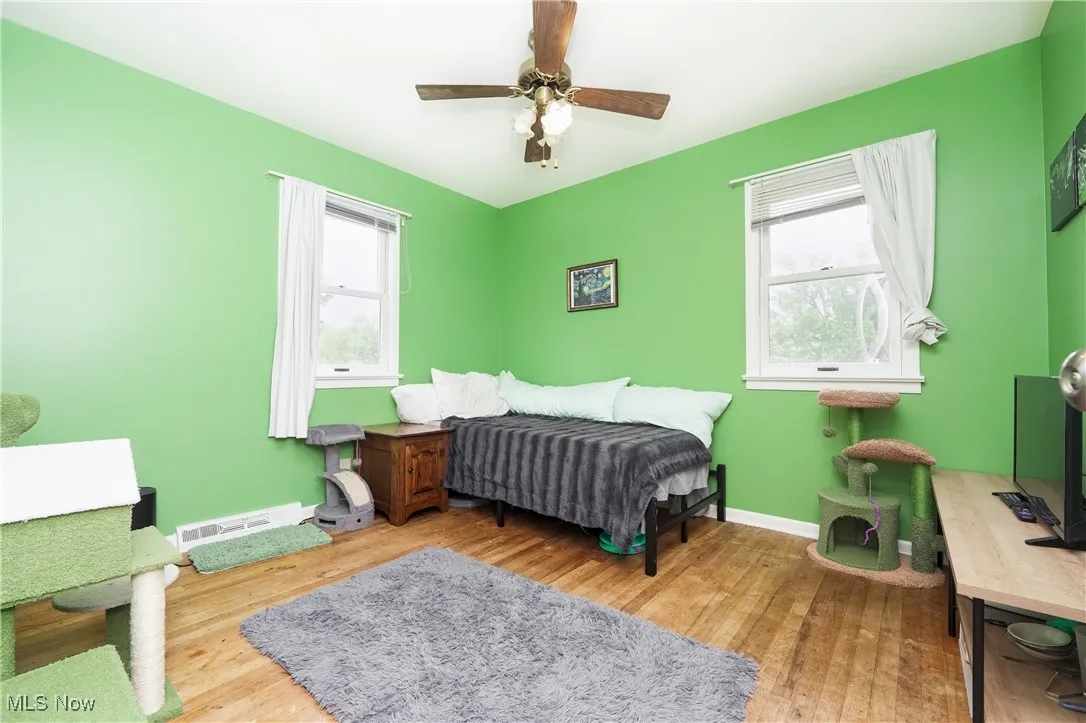 Bedroom featuring wood finished floors and a ceiling fan