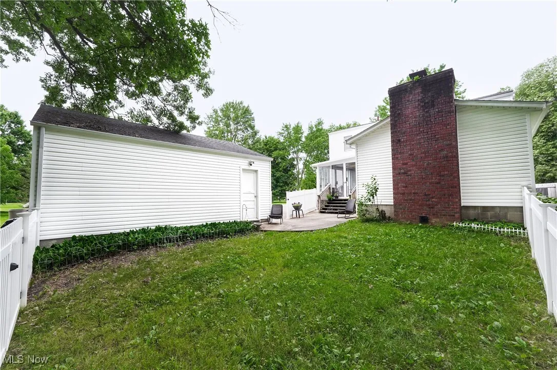 Fenced backyard featuring entry steps and a patio