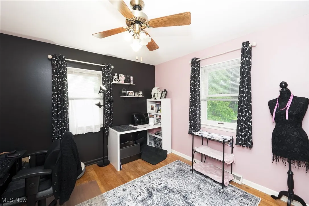 Home office featuring a ceiling fan and light wood finished floors