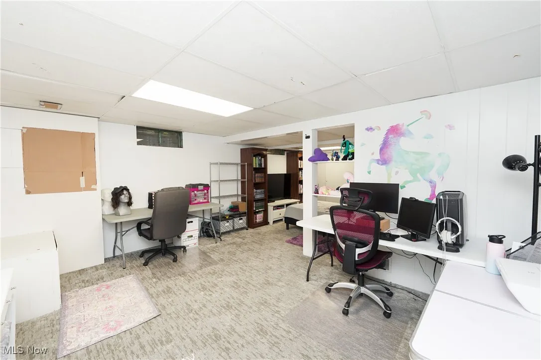 Office area with a paneled ceiling