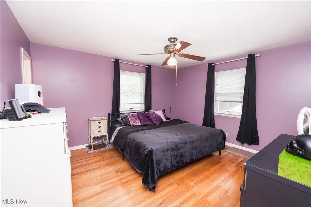 Bedroom with light wood finished floors and ceiling fan