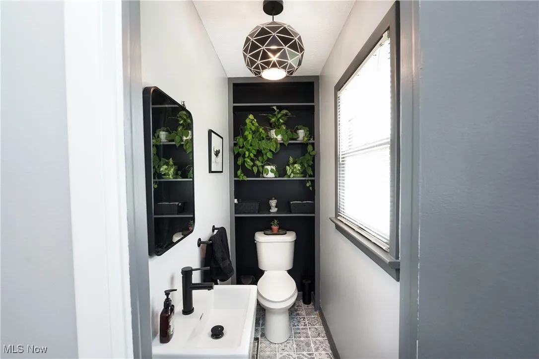Half bathroom featuring toilet and a sink