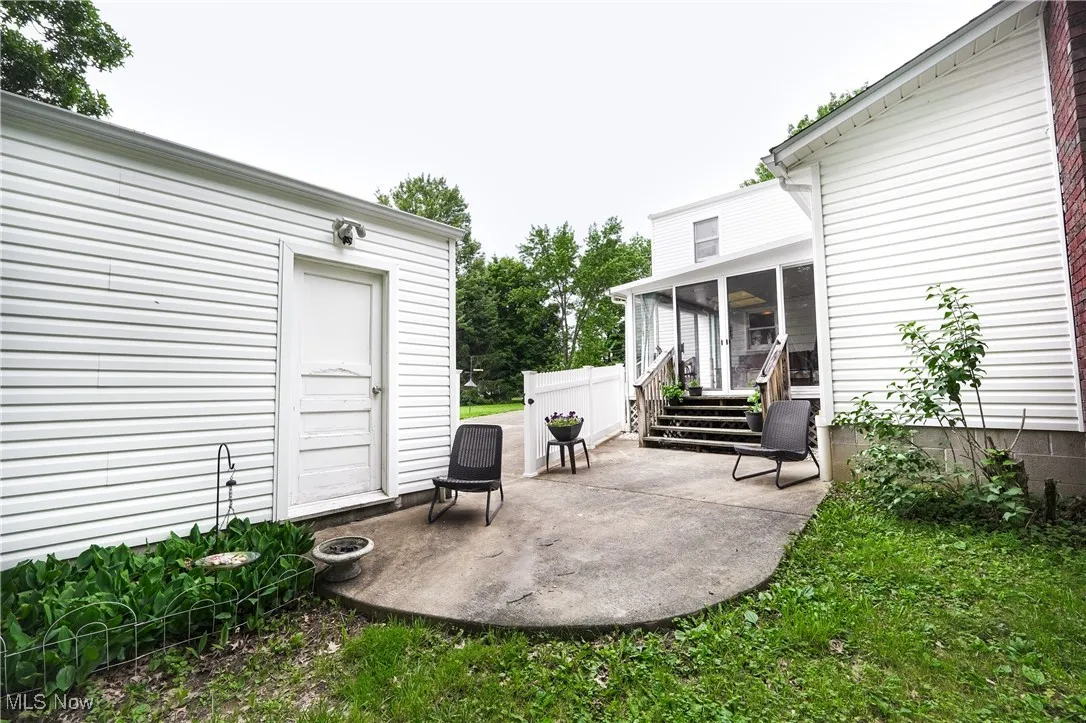 View of patio featuring a sunroom