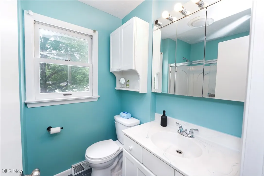 Full bathroom featuring vanity and a shower stall