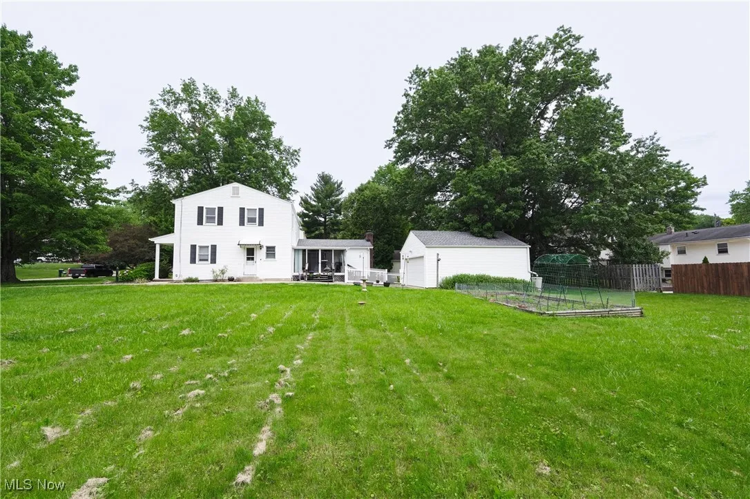 View of yard featuring an outbuilding and a garden