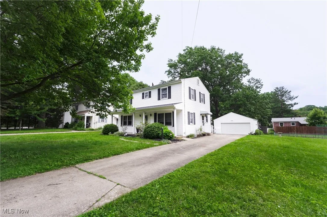 View of front of home featuring an outbuilding and a garage