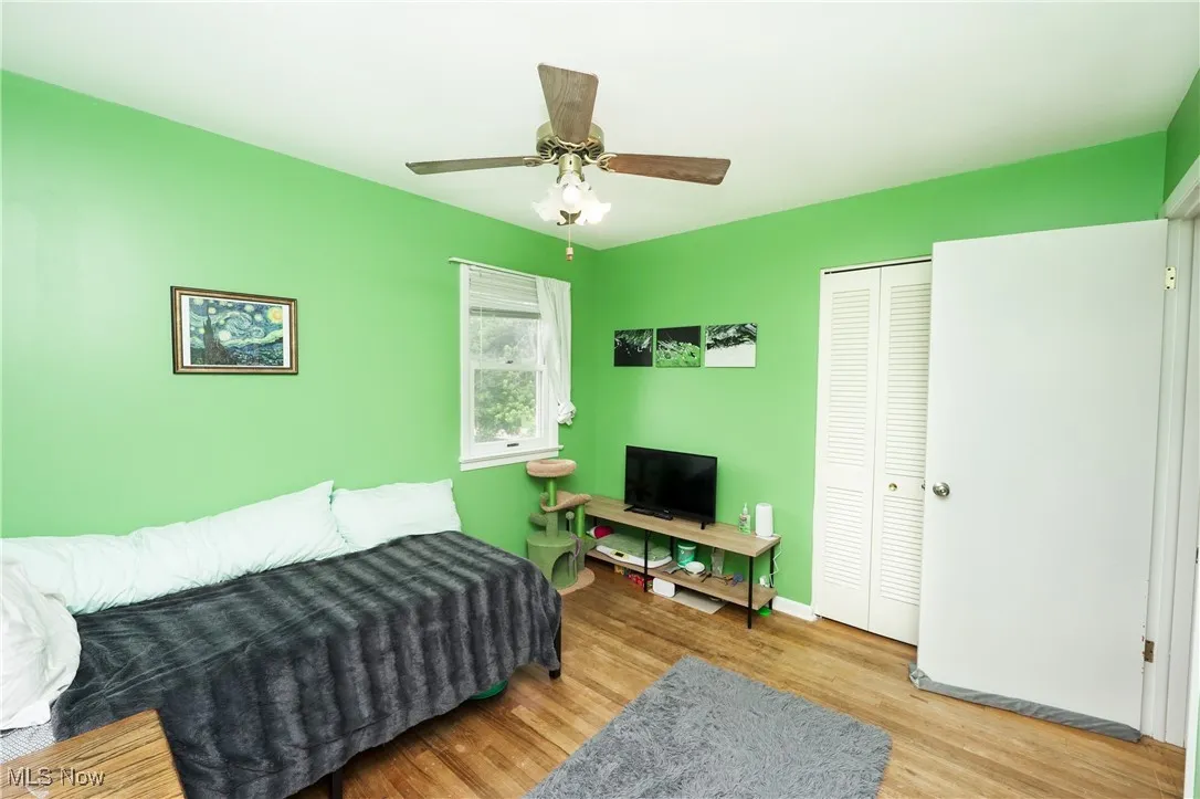 Living room with wood finished floors and a ceiling fan
