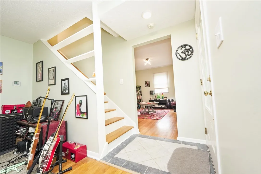 Foyer entrance with wood finished floors and stairway