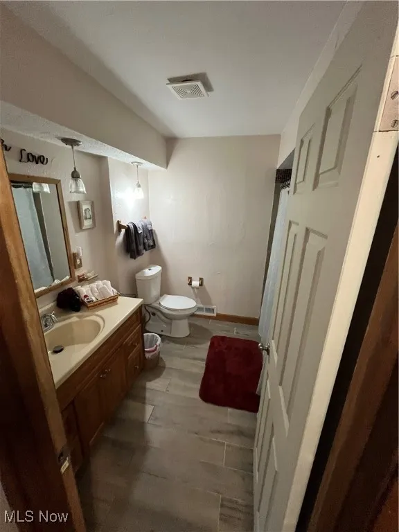 Bathroom with vanity and wood finished floors