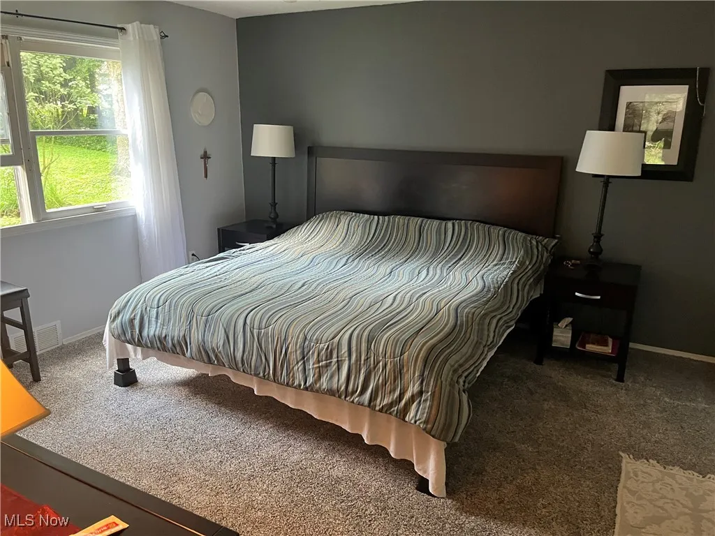 Carpeted bedroom featuring baseboards