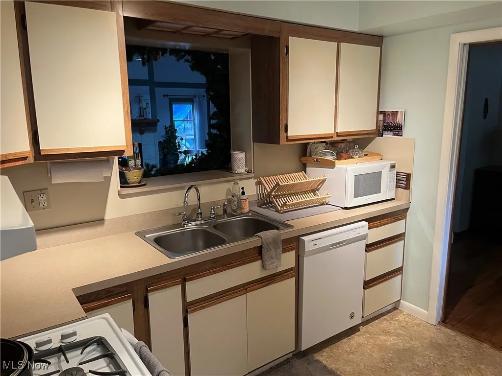 Kitchen with white appliances and light countertops