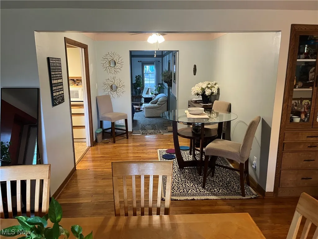 Dining area featuring wood finished floors and a ceiling fan