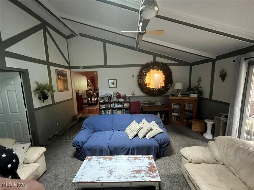 Living room with carpet floors and ceiling fan