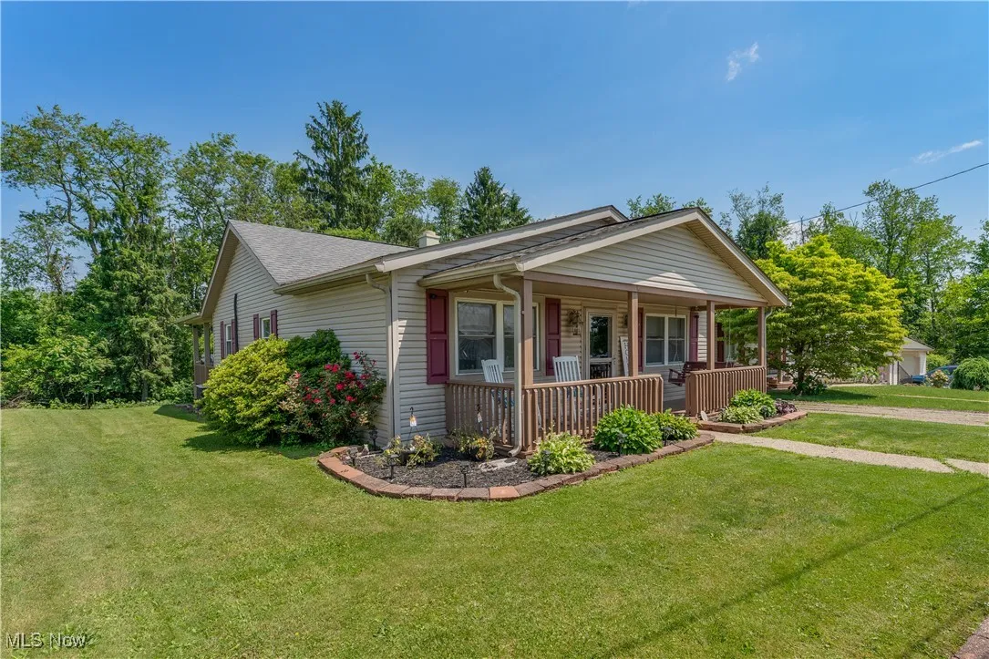View of front of house with a porch and a front yard