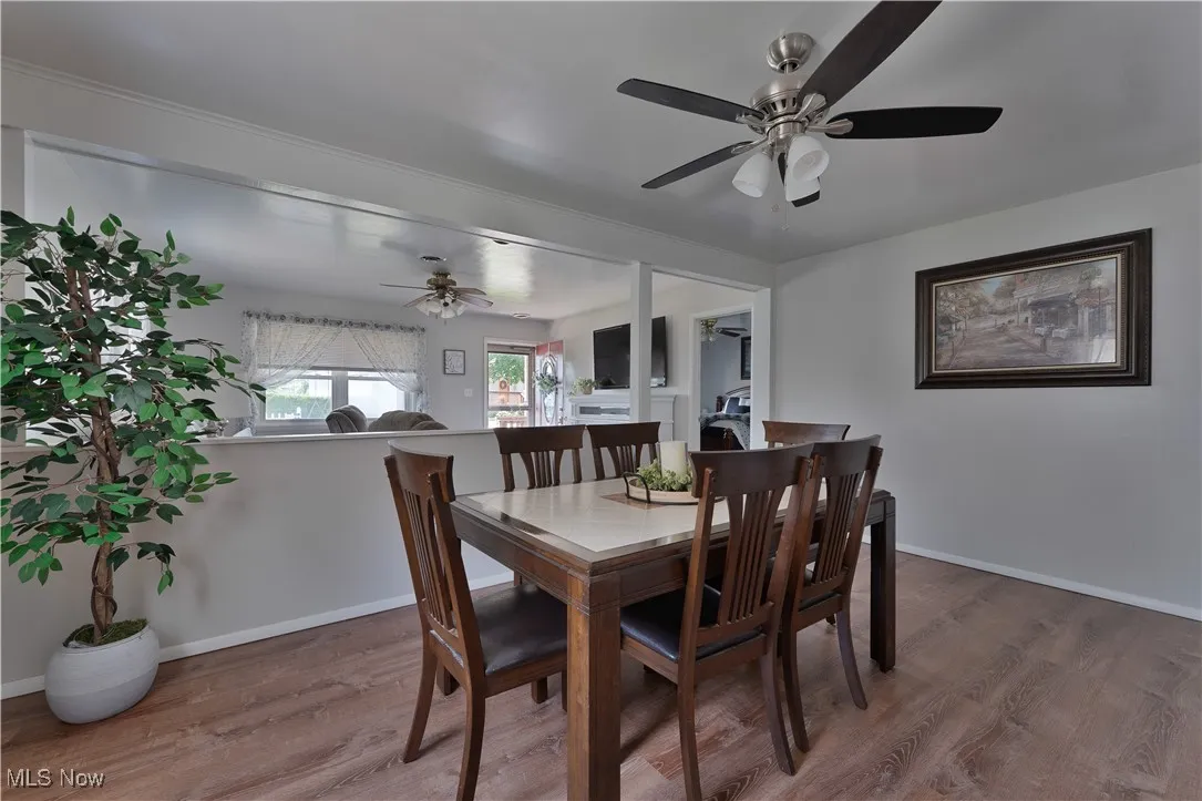 Dining space featuring wood finished floors and a ceiling fan