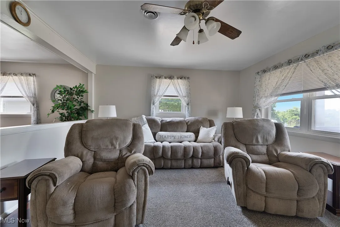 Living room with a ceiling fan and carpet floors