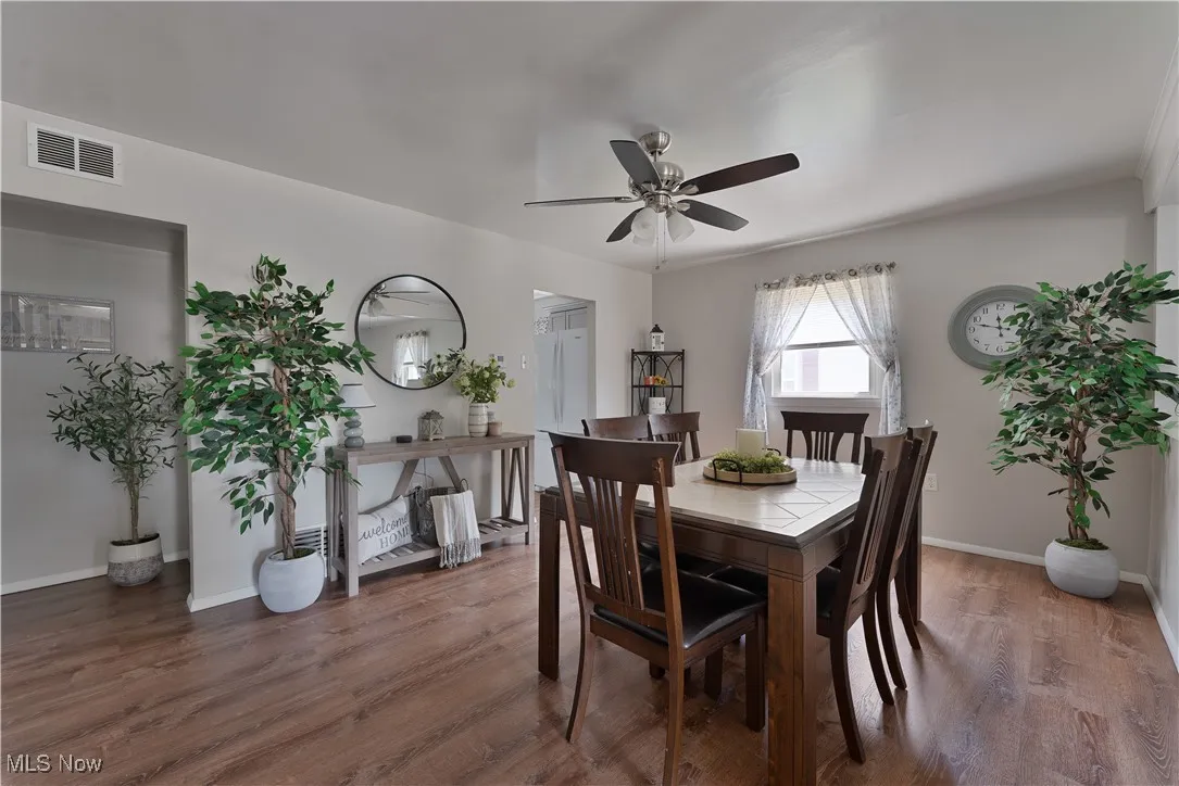 Dining area featuring a ceiling fan and wood finished floors