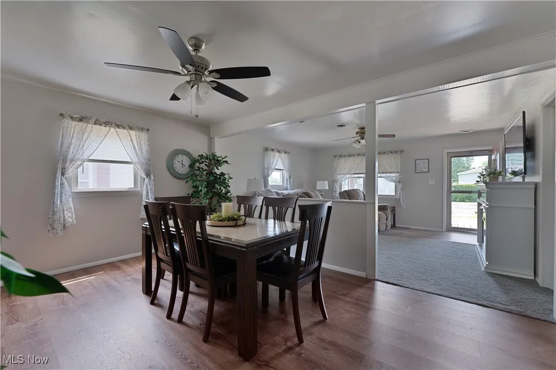 Dining area with ceiling fan and wood finished floors