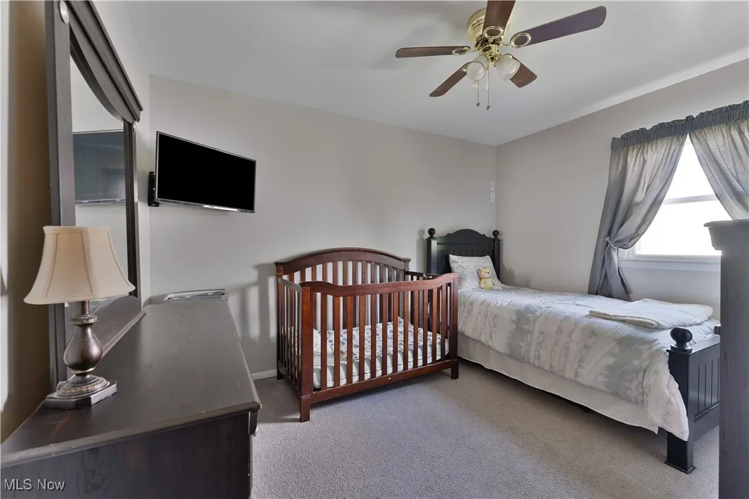 Bedroom with carpet and ceiling fan