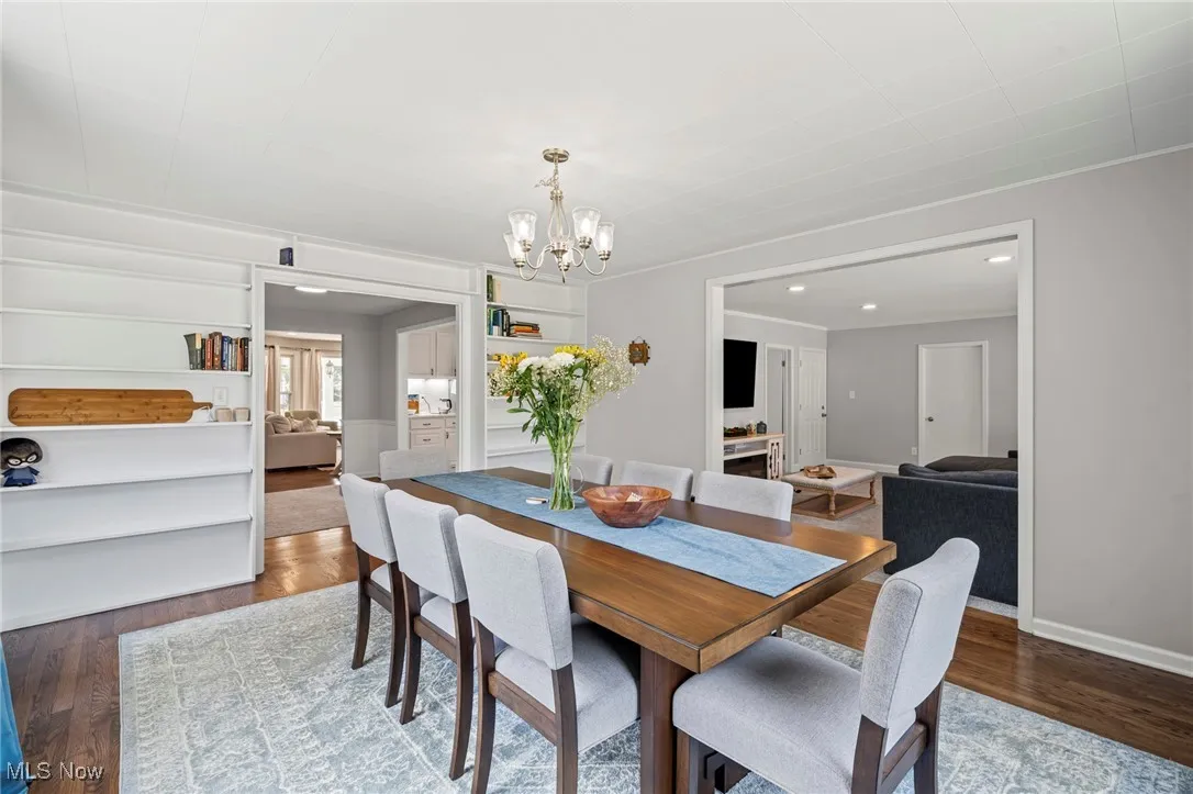 Dining room featuring a chandelier, wood finished floors, and recessed lighting